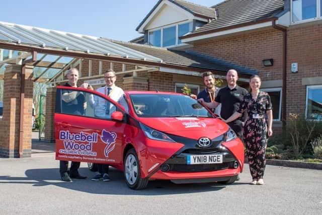 Burrows’ Mark Taylor (left) and Adam Hughes (fourth left) hand over the keys to Russ Hall (second left), David Hall and Rachael Dawes from Bluebell Wood