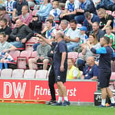 Paul Warne and assistant manager Richie Barker on duty at Wigan. Pictures: DAVE POUCHER