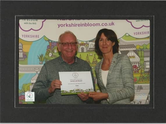 Cllr Ian Lloyd receives the award from Newby Hall owner Lucinda Compton.