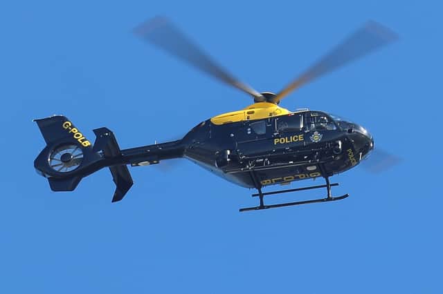 A police helicopter pictured observing the road pursuit from the air yesterday.