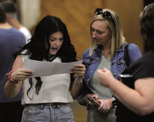 Students at Wales High School receive their results