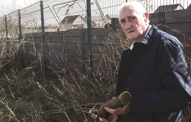 President of Swallownest Miners Welfare Club, Pete Overton, by the fence where the hedgerow has been cut down by developers. 230252-3