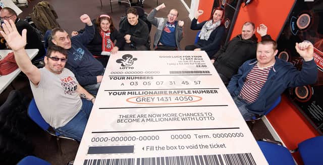 Members of the Rotherham United Community Sports Trust appeal to the winner of the winning ticket to come forward.