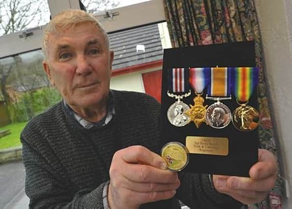 Garry Cox with his grandad Percy Beech's replacement medals. 170165