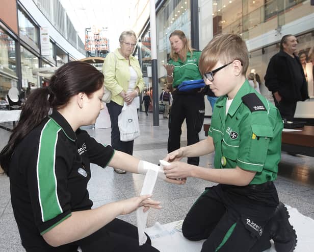 St John Ambulance volunteers demonstrating first aid skills.