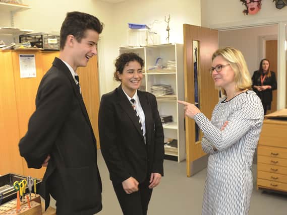 Justine Greening MP, secretary of state for education shares a joke with head boy Will Monteiro (15) and head girl Safia Ajaib (15)