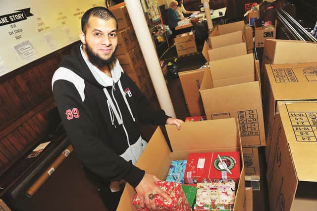 Volunteer Mohammed Usman packing some of the boxes for last year's appeal