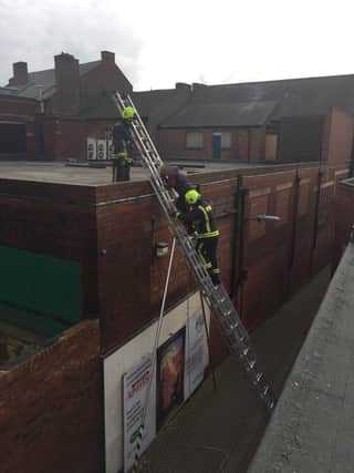 The boy being rescued from the roof