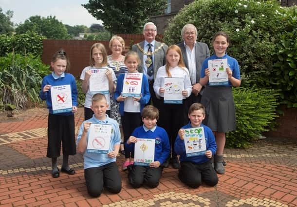 The Mayoress of Rotherham, Mrs Sandra Buckley (back row, left), the Mayor of Rotherham, Cllr Alan Buckley (back row, centre) and cabinet member for adult social care and public health, Cllr David Roche (back row, right) with the winning pupils.