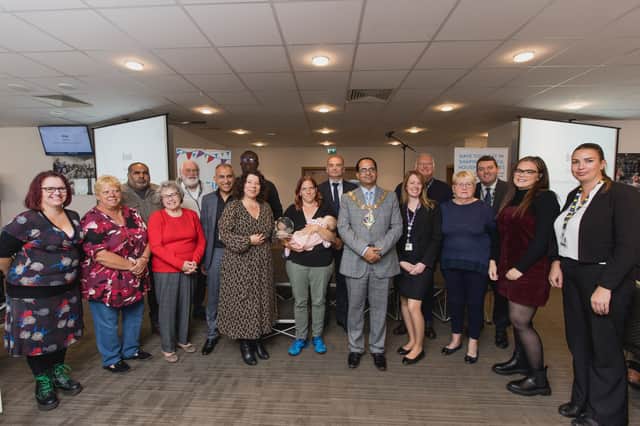 Jenny Osbourne from Tpas presents the award to the Mayor of Rotherham, Cllr Tajamal Khan, staff from RMBC’s housing team and tenants
