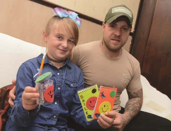Darren Parker of Kilnhurst who fought in the white collar boxing show at Bramall Lane to raise money for Cancer Research UK, pictured with his sister Karla Hitchens (9) who was inspired by him and made and sold notepads and pencils which raised £131 for the charity. 171187
