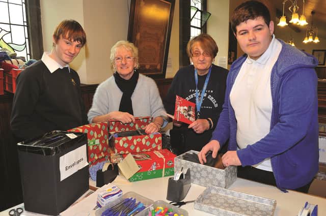 The Samritans Purse Operation Christmas Child processing centre at the Talbot Lane Methodist Church is again in full swing with shoeboxes arriving daily. Helping out are pupils from The Willows School at Thurcroft, Joshua Toothill (left) and Morgan Troop with Hazel Adelbogun (right) district co-ordinator and Maureen Pearson, processing centre manager. 171940-5
