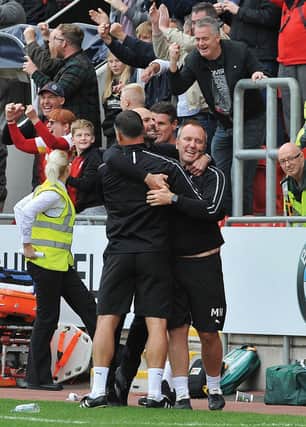 Paul Warne and his staff celebrate Saturday's win against Derby.