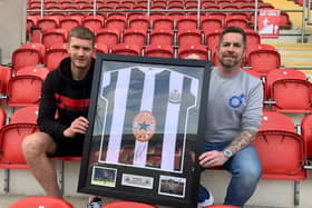 Michael Smith is presented with his Alan Shearer shirt by Kev Johnson