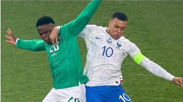 Chiedozie Ogbene tussles with Kylian Mbappe in last night's Euro 2024 qualifier.