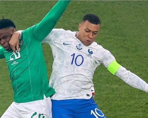 Chiedozie Ogbene tussles with Kylian Mbappe in last night's Euro 2024 qualifier.
