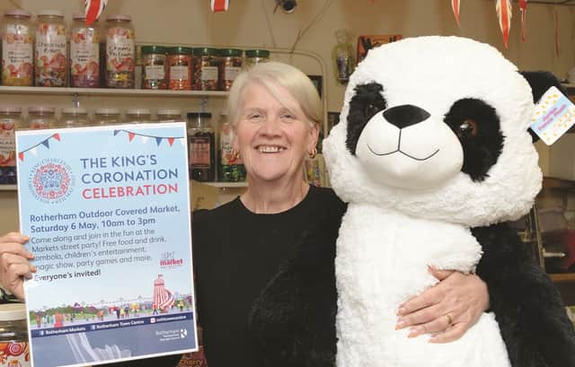Market trader Ann Savage with a raffle prize and poster for the town centre coronation celebration.