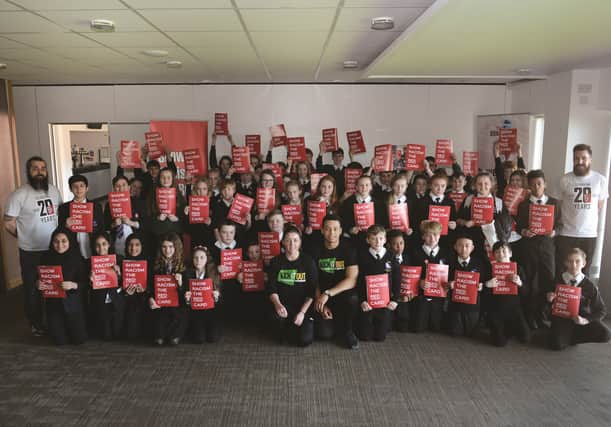 Students from Thrybergh Academy, Wickersley School and Sports College, Oakwood High School and St Bernard's Catholic High School, attended the recent Show Racism the Red Card event at the AESSEAL New York Stadium. They are pictured with campaign co-ordinator Gavin Sutherland, campaigner James Kingett (right), Premier League Kicks co-ordinator and NCS assistant officer Ben Winter (centre right) and inclusion and disability officer Trudi Race (centre left). 170499-4