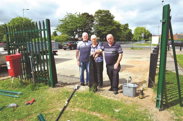 Ged Nightingale, parish council chairman, Cllr Irene Nightingale and parish hall caretaker, Royce Hall in front of the vandalised fence around the Gordon Bennett Memorial Hall at Thurcoft which lasted hours before it was attacked. 170987-5