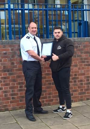Chief Insp Ferguson presenting Martin Putnoky with his commendation.