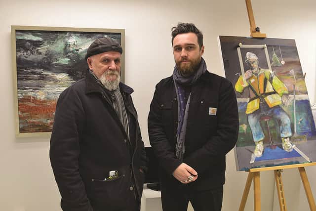 Artist Paul Dearden (left) and Laurie Allport, son of the late Derek Allport, with a painting which Derek was still working on when he died.