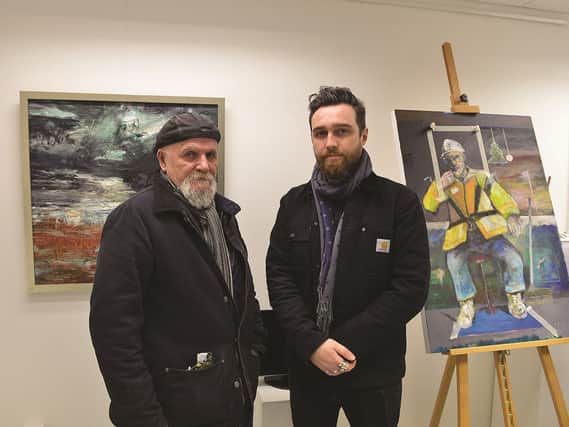 Artist Paul Dearden (left) and Laurie Allport, son of the late Derek Allport, with a painting which Derek was still working on when he died.