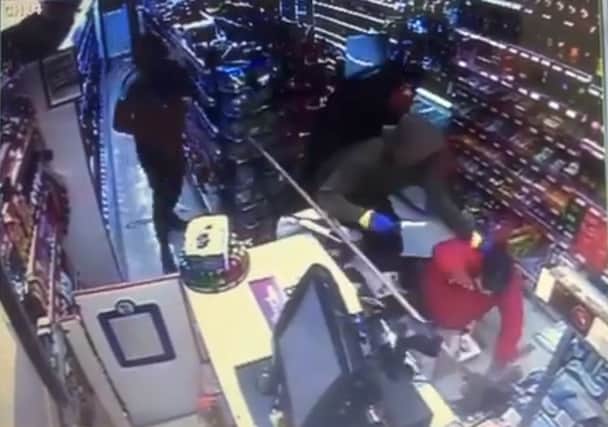 Four armed robbers attack the shop keeper and raid the till