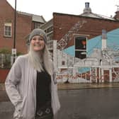 Vicky Hilton with the finished mural on the wall of the 1915 Bar in the town centre. 171372