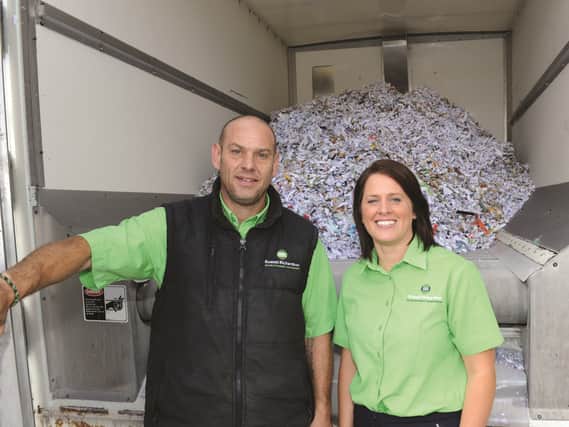 Seen with the shredded waste are Bryan Cupitt and Emma Moorhouse. 171573-4