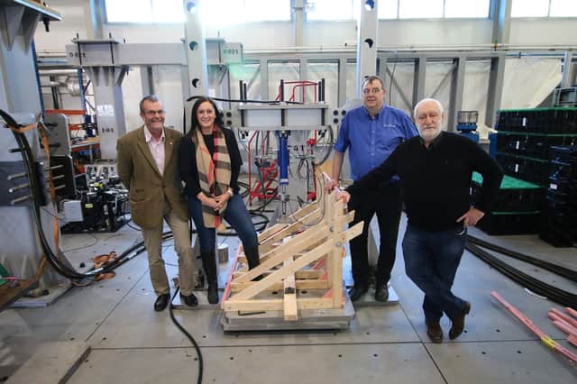From left: Phil Spiers, head of the Advanced Structural Testing Centre at the AMRC; Keah general manager Emma Johnson; Shane Smith, AMRC technical lead for structural testing; and Keah director Ken Johnson, with the Keah roofing structure installed for testing in the tall rig at the AMRC