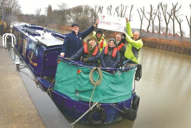 Staff and trustees celebrate at the lock