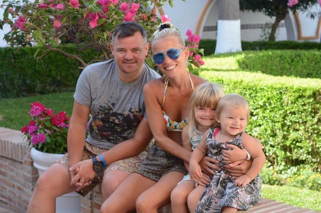 Helen Davy with her husband John, who passed away four years ago, and their children Annalise (8) and Kairen (5)