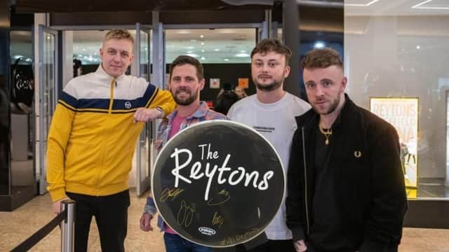The Reytons with their signed drum skin outside their Meadowhall pop-up shop