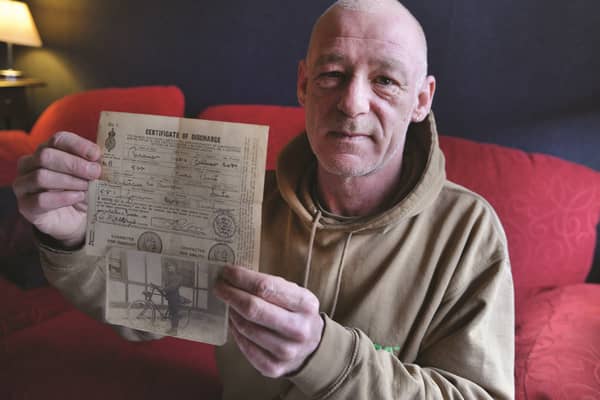 Tony Drabble of Parkgate with a photograph of his sailor grandfather John Oultram and his certificate of discharge. 180295-2