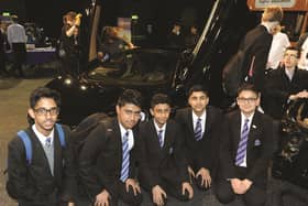 Oakwood High School pupils are seen with a McLaren 570. 180576-9