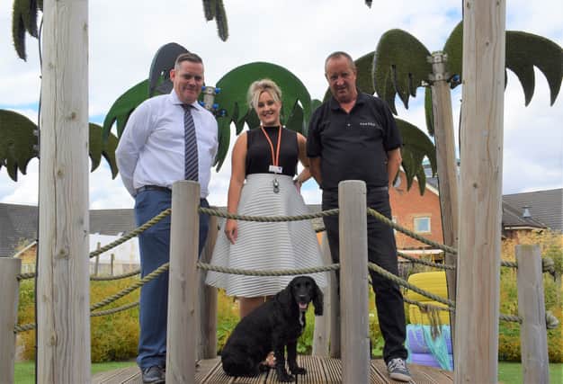 Craig Naylor-Smith, managing director of Parseq’s finance and administration division; Anna Gott of Bluebell Wood Children’s Hospice; and Mick Gott, warehouse manager, facilities support team, Parseq, with George the dog.