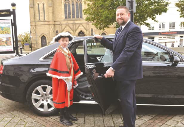 The junior Mayor of Rotherham Etienne Henderson is helped into the mayoral car by mayor's attendant Dean Walton