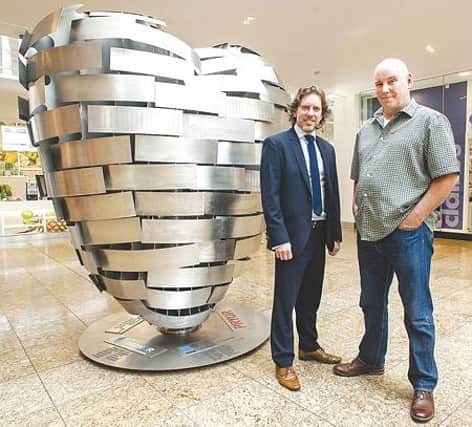 Richard Pinfold, marketing director at Meadowhall, and Steve Mehdi, The Steel Man and Heart of Steel artist