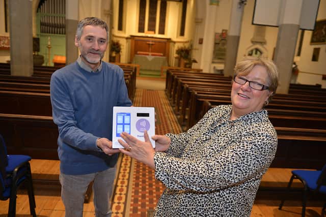 Church wardens Steven Blake and Maureen Whatley with the new contactless payment system