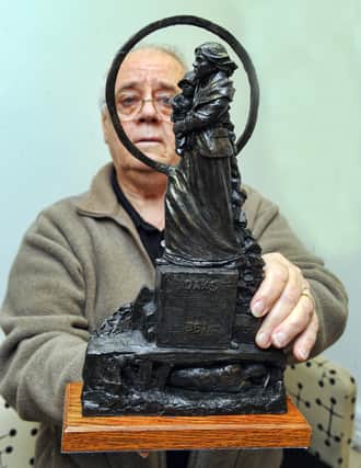 Barry Moore, treasurer of People and Mining, with a model of the Graham Ibbeson-designed Oaks Colliery disaster memorial.
