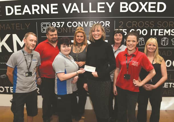The community team at Next's Dearne Valley Box Distribution centre at Manvers handed over a cheque £3,000, money raised through various fundraising events, to Nicola McMullen (fourth right) of the James Montgomery Academy Trust. The money will be used for resources for the Shining Stars after schools clubs run across the academy's schools. 171707