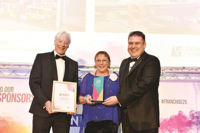 Steve and Carol Morris from Signs Express Sheffield and Rotherham accepting their Best Sign Project award with managing director Craig Brown