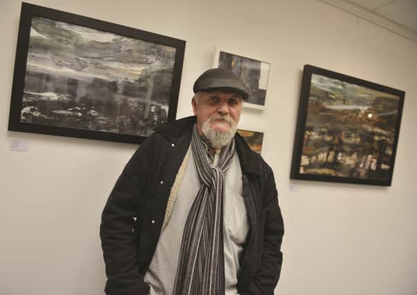 Artist Paul Dearden with some of his work