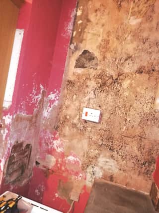 Damp damage to one of Khan's properties