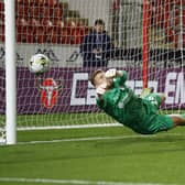 Rotherham United's Jordan Phillips makes the second of his two penalty saves against Morecambe in the Carabao Cup. Pictures by Jim Brailsford