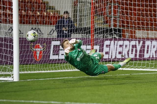 Rotherham United's Jordan Phillips makes the second of his two penalty saves against Morecambe in the Carabao Cup. Pictures by Jim Brailsford