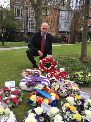 Mr Healey lays a wreath at the service.