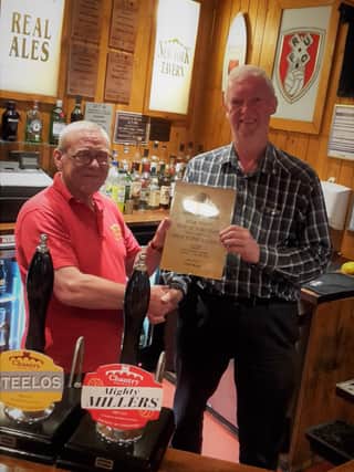 L-R: New York Tavern landlord Chris Brown receives the award from Dr Steve Burns, chairman of Rotherham CAMRA
