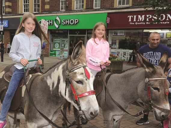 RMBC events team recently held an Animal Magic day in All Saints Square, with animals to pet and stroke, along with donkey rides and bucking bronco sheep. Seen having a donkey ride are sisters Daisy (10) and Molly Garbett (8). 171316-11