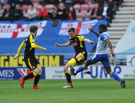 Ben Purringon battles for possession at Wigan last Saturday. Pictures: TREVOR PRICE